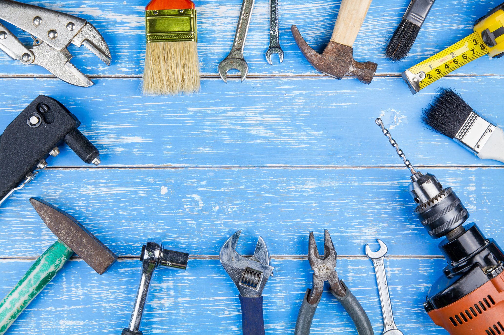 Construction tools on blue wooden table background